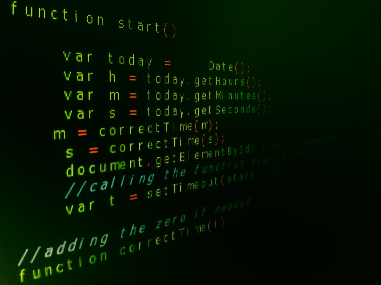 Services Close-up of JavaScript code on a computer screen with green text highlighting syntax.